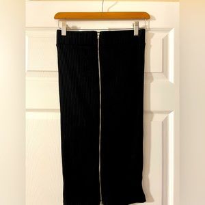 Ribbed black cotton pencil tube skirt with dual adjustable zippers. 24.5 inches